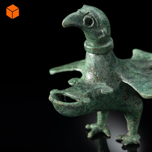 Öllampe aus grünlicher Bronze, die in der Form eines Adlers gestaltet ist.